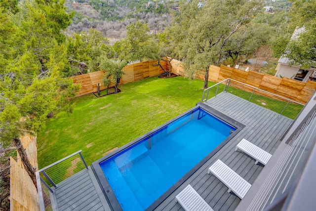 view of pool featuring a yard and a wooden deck