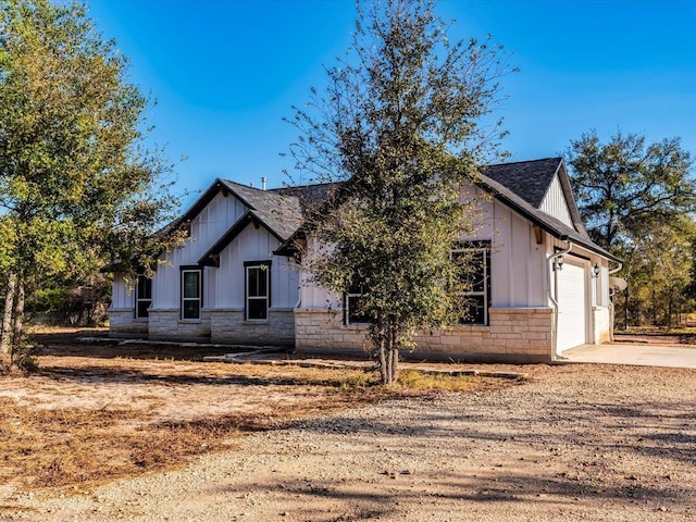 modern inspired farmhouse with a garage