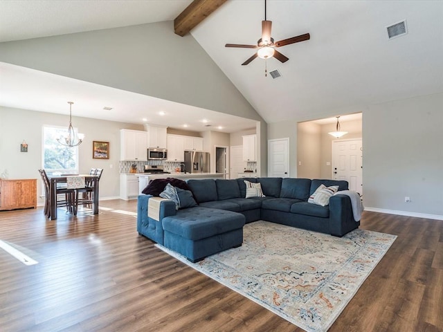 living room with beam ceiling, dark hardwood / wood-style floors, ceiling fan with notable chandelier, and high vaulted ceiling