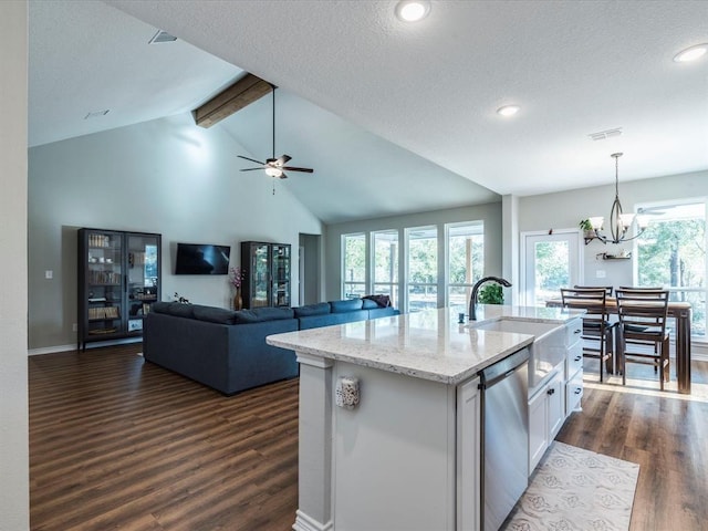 kitchen featuring dishwasher, white cabinetry, sink, hanging light fixtures, and a center island with sink