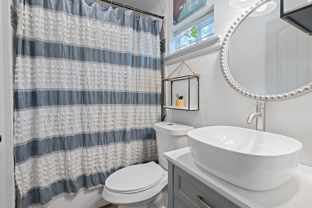 full bathroom featuring toilet, shower / bath combo, and vanity