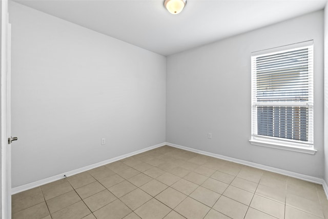 unfurnished room with light tile patterned flooring