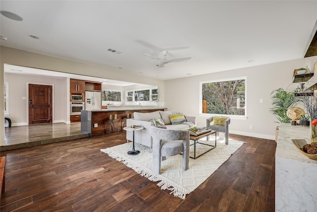 living room with ceiling fan and dark hardwood / wood-style floors