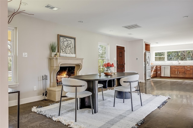 dining space with sink and wood-type flooring