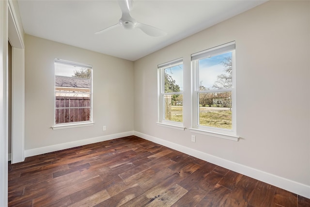 empty room featuring ceiling fan and dark wood-type flooring