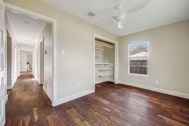 unfurnished bedroom with ceiling fan, a closet, and dark hardwood / wood-style flooring