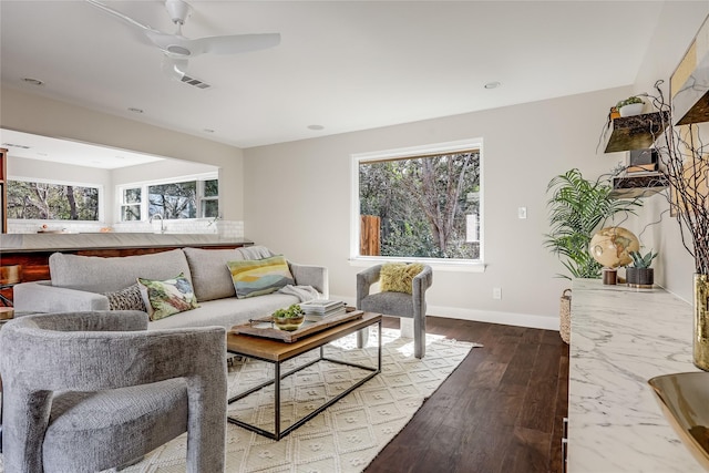 living room featuring ceiling fan, a wealth of natural light, and hardwood / wood-style flooring