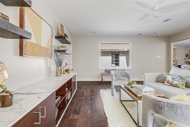 living room with ceiling fan and dark wood-type flooring