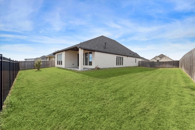 rear view of house featuring a patio area and a lawn