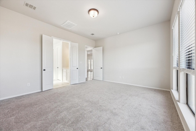 unfurnished bedroom with light carpet