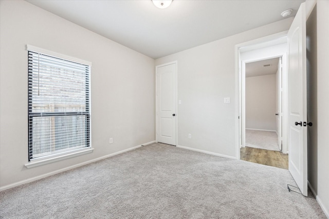 unfurnished bedroom featuring light carpet