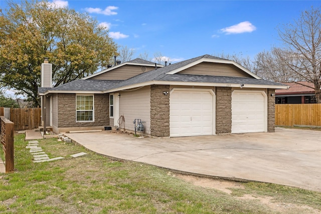 ranch-style house with a garage and a front yard