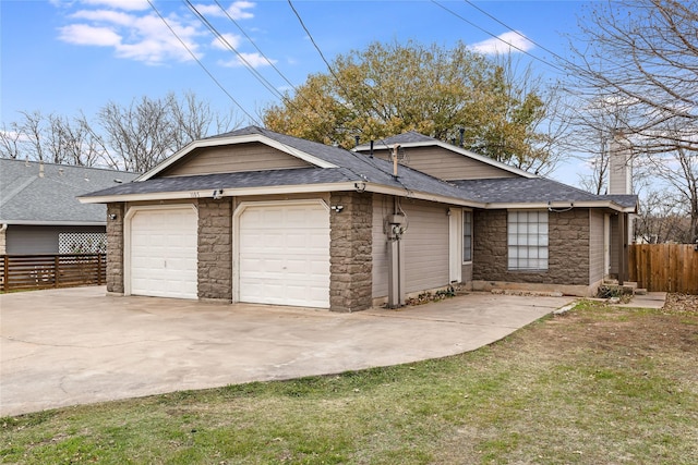 view of side of property featuring a garage and a lawn