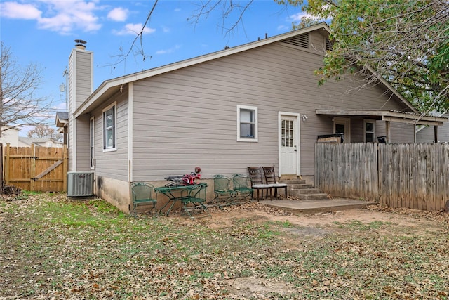 back of house with central AC unit and a patio area