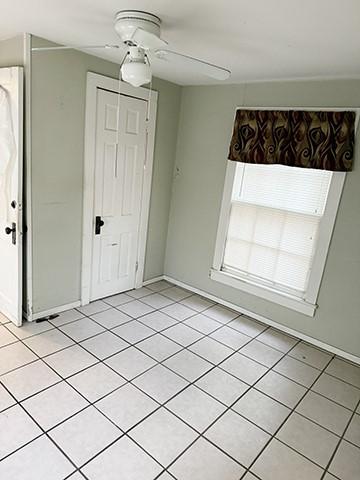 interior space with ceiling fan