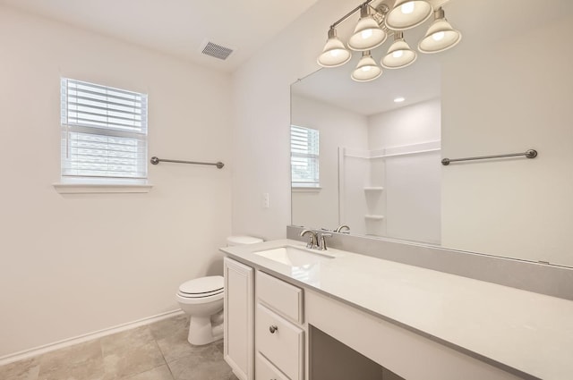 bathroom with vanity, toilet, and tile patterned flooring