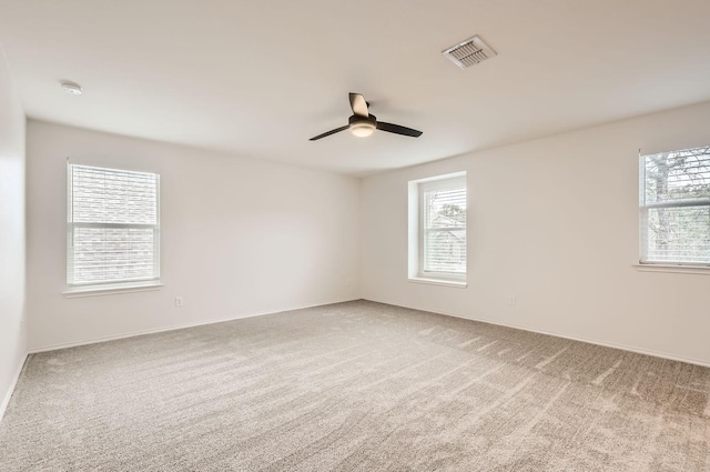 unfurnished room featuring ceiling fan and carpet floors