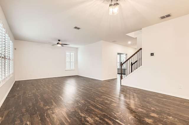 unfurnished living room featuring dark wood-type flooring and ceiling fan