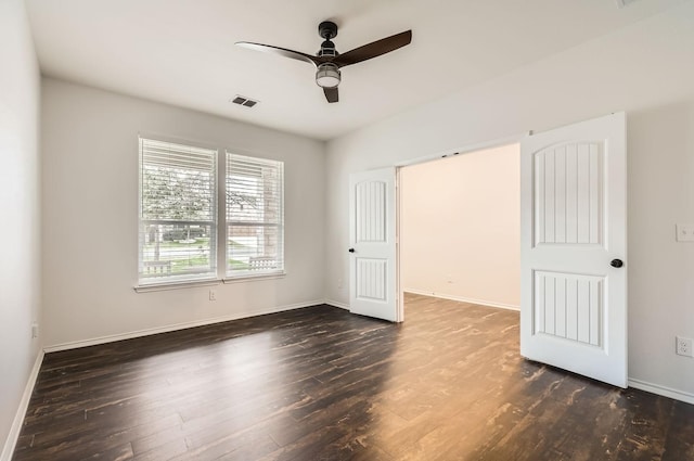 unfurnished bedroom featuring dark hardwood / wood-style floors and ceiling fan