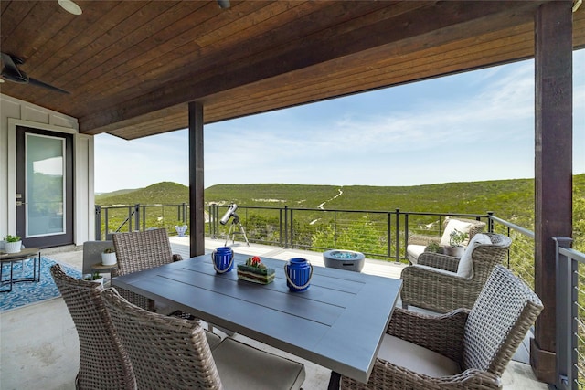 view of patio featuring ceiling fan, a rural view, and a mountain view