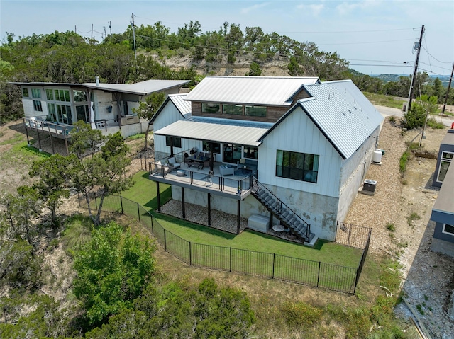 rear view of property featuring a deck