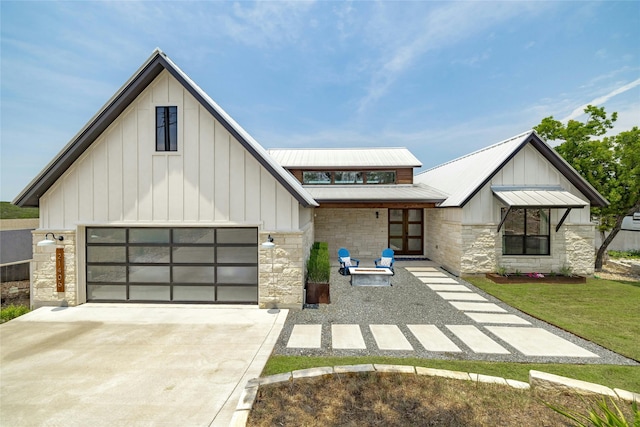 modern farmhouse style home with a front yard and a garage