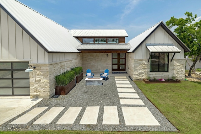 entrance to property featuring a yard and a patio