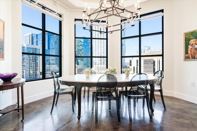 dining space featuring a notable chandelier and concrete flooring