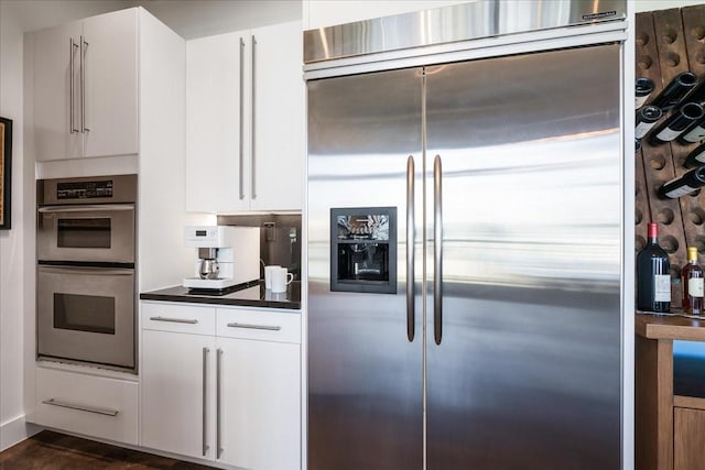 kitchen with white cabinets and appliances with stainless steel finishes