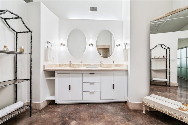 bathroom featuring vanity and concrete flooring