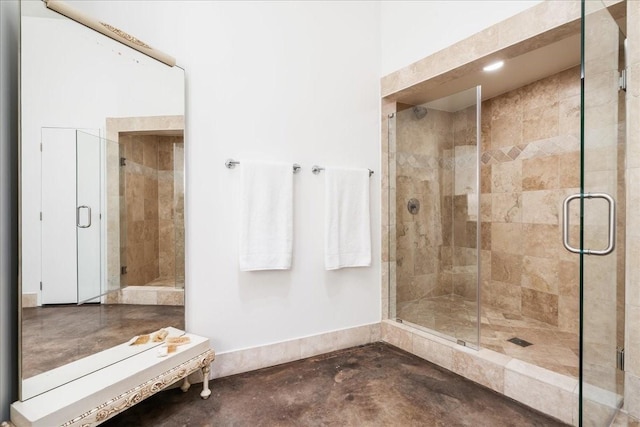 bathroom with concrete flooring and a shower with door