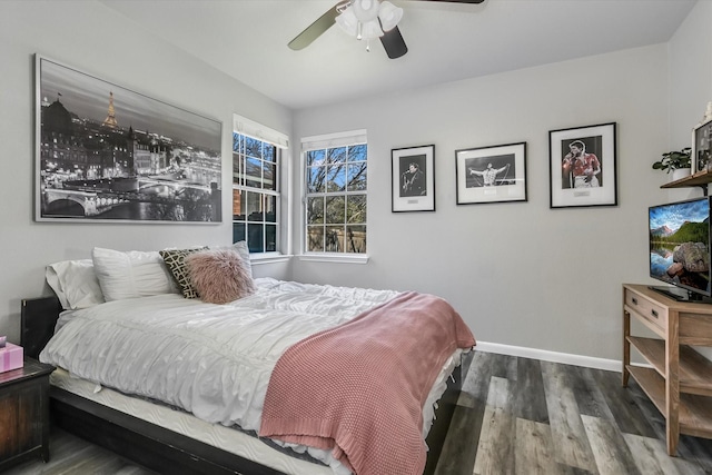 bedroom with ceiling fan and dark hardwood / wood-style floors