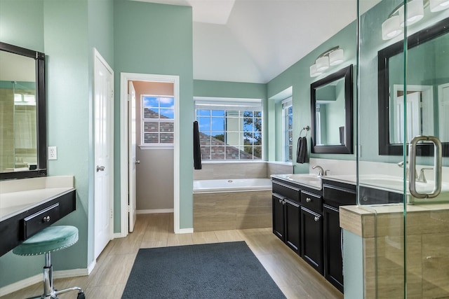 bathroom featuring lofted ceiling, vanity, and independent shower and bath