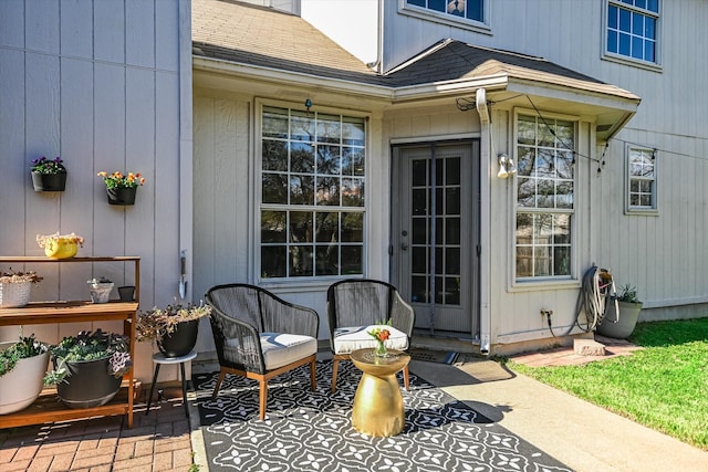 view of exterior entry with a patio