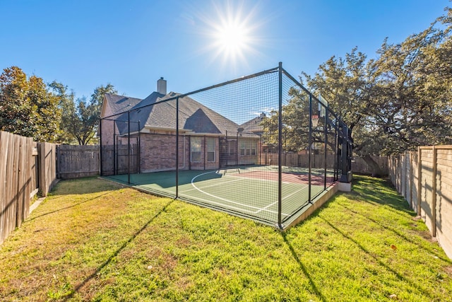 view of basketball court with a lawn