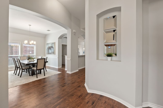 interior space with dark hardwood / wood-style floors and a notable chandelier