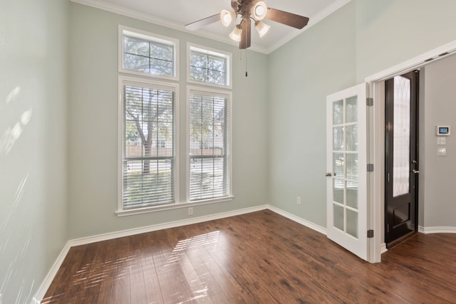 unfurnished room with ceiling fan, dark hardwood / wood-style flooring, and crown molding