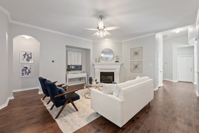 living room with ceiling fan, dark wood-type flooring, and crown molding