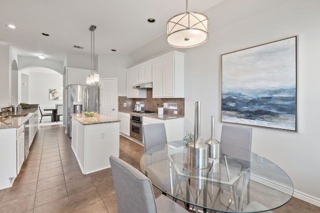 dining space with light tile patterned flooring and sink