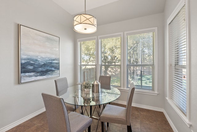 dining space with dark tile patterned flooring