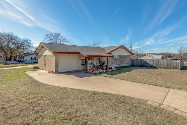 ranch-style house featuring a front lawn, covered porch, and a garage