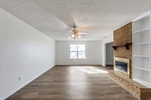 unfurnished living room with a textured ceiling, wood-type flooring, a fireplace, built in features, and ceiling fan