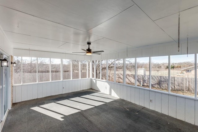 unfurnished sunroom featuring ceiling fan