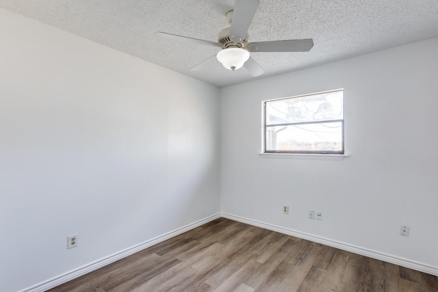 spare room with ceiling fan, a textured ceiling, and hardwood / wood-style flooring