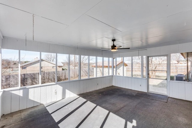 unfurnished sunroom with ceiling fan