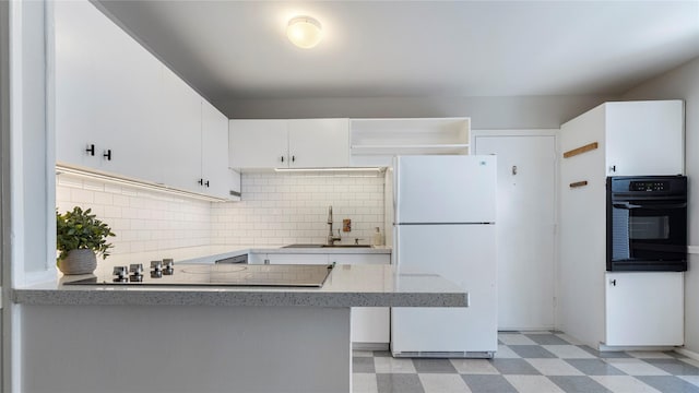 kitchen featuring black appliances, backsplash, sink, and white cabinetry