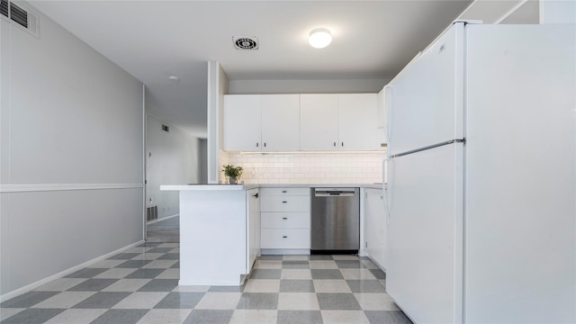 kitchen featuring white fridge, white cabinetry, dishwasher, and tasteful backsplash