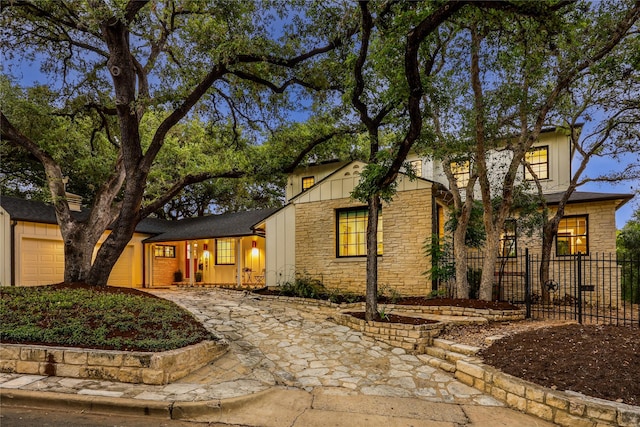 rear view of property featuring a garage