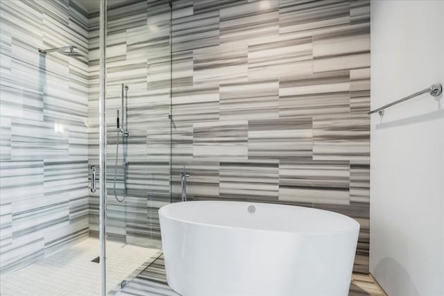 360 Nueces St Unit 4305, Austin, TX 78701 - bathroom featuring a freestanding tub, tile walls, and a stall shower