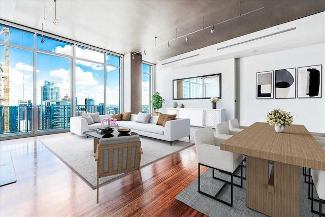 living room with a wall of windows and hardwood / wood-style floors